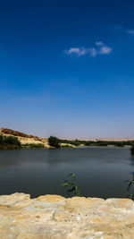 Scenic view of lake against blue sky