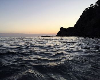 Scenic view of sea against clear sky during sunset