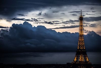 Low angle view of tower against cloudy sky