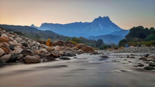 Scenic view of rocky mountains against sky during sunset