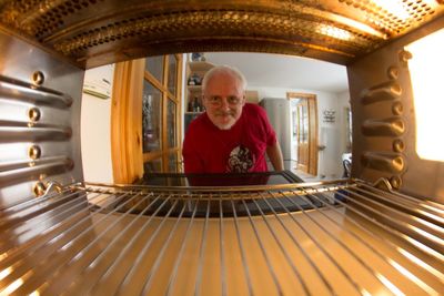 Portrait of man seen through illuminated oven