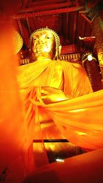 Low angle view of statue against temple building