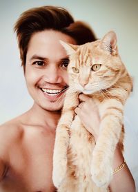 Portrait of a smiling young woman with cat