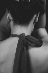 Rear view of woman with textile tied in neck