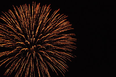 Low angle view of fireworks against sky at night