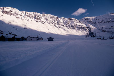 Scenic view of snow covered mountains against sky