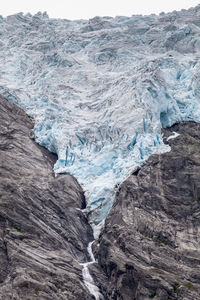 Close-up of glacier by rock formations