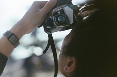 Close-up of woman photographing camera