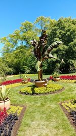 Statue by fountain in park