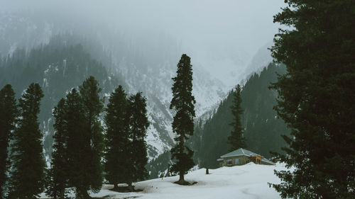 Panoramic view of snow covered mountains against sky