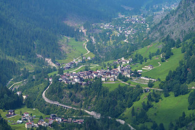 High angle view of townscape and trees on field