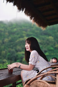 Portrait of woman sitting outdoors