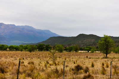 View of countryside landscape against mountain range