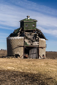 Traditional windmill on field against sky