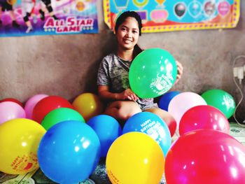Portrait of smiling boy with balloons