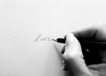 Midsection of person holding paper with text