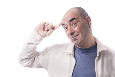 Portrait of man making face against white background