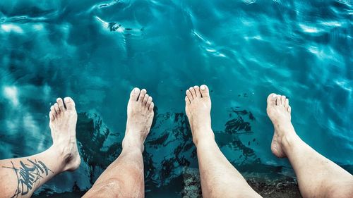 Low section of woman relaxing in water