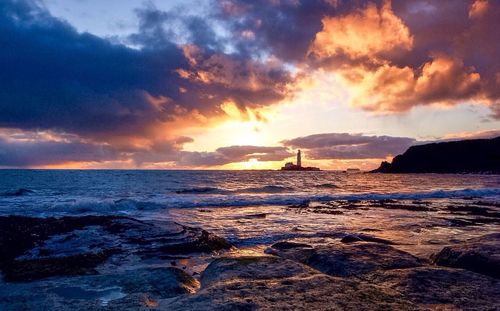 Scenic view of sea against cloudy sky