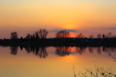 Scenic view of lake against romantic sky at sunset