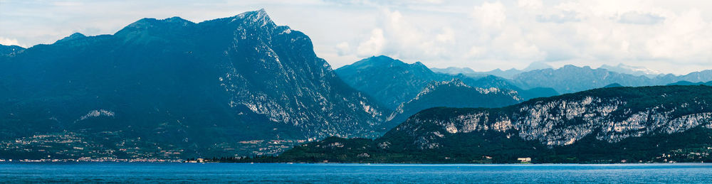 Panoramic view of sea and mountains against sky