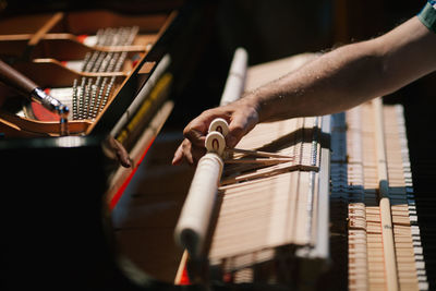 Cropped image of hand working on piano