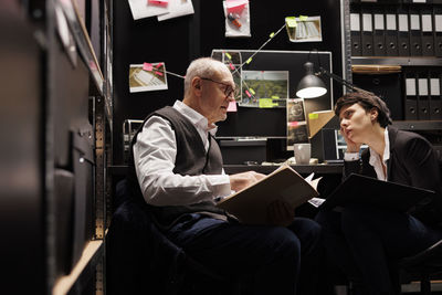 Man using laptop while sitting in office