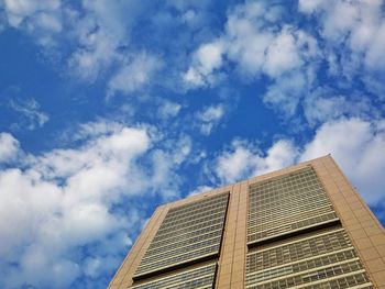 Low angle view of building against cloudy sky