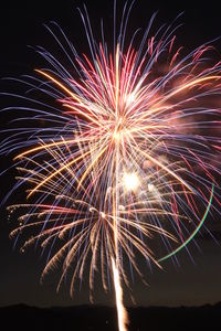 Low angle view of firework display at night