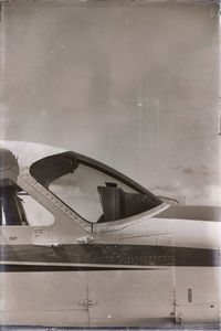 Airplane seen through wet glass window