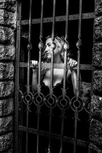 Close-up of person in metal grate