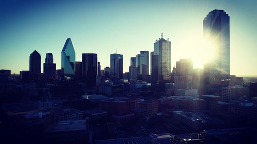 Modern buildings in city against clear sky