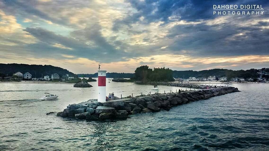 water, sky, transportation, sea, cloud - sky, nautical vessel, waterfront, mountain, boat, tranquil scene, tranquility, cloud, scenics, sunset, mode of transport, beauty in nature, rippled, nature, cloudy, rock - object