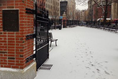 Street amidst buildings in city during winter