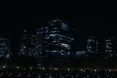 Illuminated modern buildings in city at night