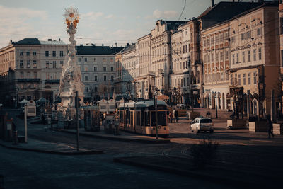 City street by buildings against sky