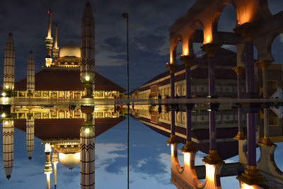 Illuminated temple against sky in city