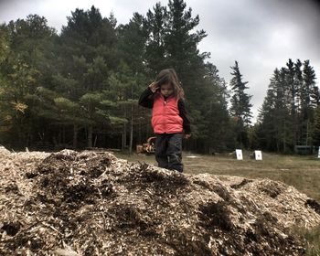 Girl walking on rock against field