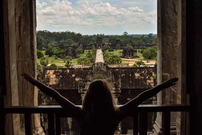 Rear view of woman looking at view against sky