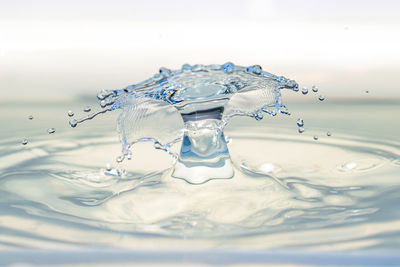 Close-up of water splashing against blue background