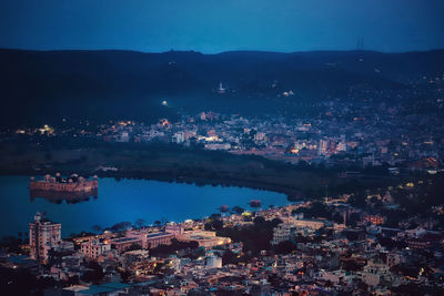 High angle view of illuminated buildings in city at night