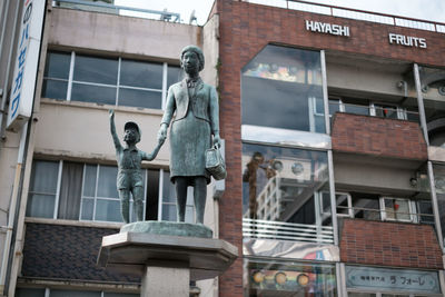 Low angle view of statue against building