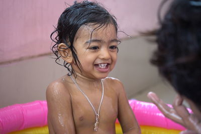 Portrait of a smiling girl with pink petals