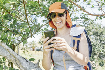 Portrait of smiling young woman using mobile phone