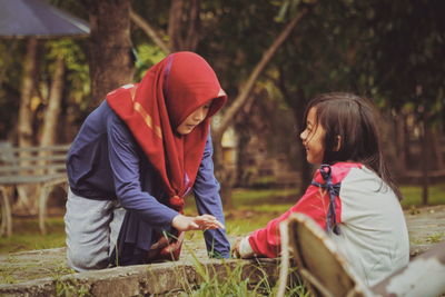 Side view of two women standing on land