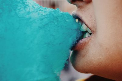 Midsection of person eating cotton candy