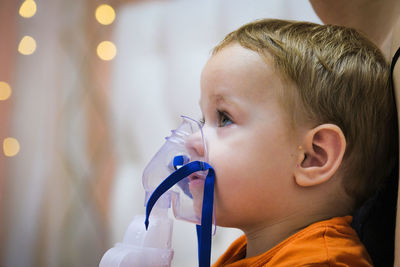 Close-up of boy blowing bubbles