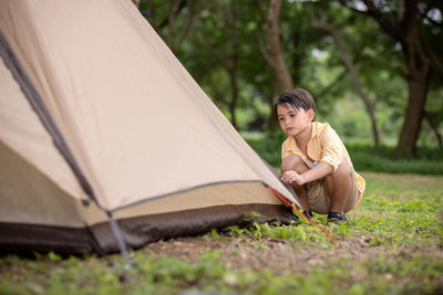 Young woman sitting on tent