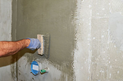 Low section of man standing by wall