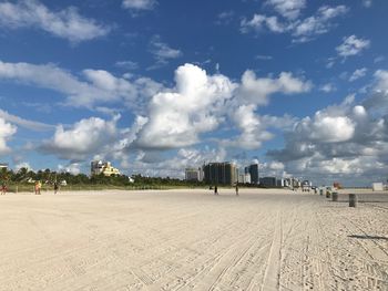 Panoramic view of beach and buildings against sky